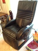Front view of the black leather massage reclining chair