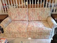 Front view of the floral pull out sofa bed showing cushions and upholstery pattern.