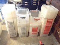 Four stacks of clear Tobo storage bins showing different handle colors and sizes