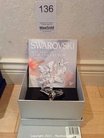 Original silver presentation box open showing certificate and figurine inset in foam