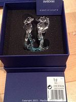 Two Swarovski crystal sea horses in original blue box with certificate