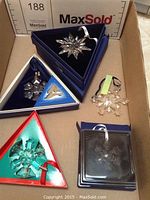 Overview of five ornaments in various original boxes and broken unboxed piece