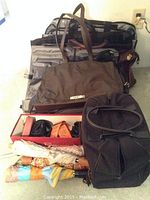 Photo showing collection of bags including Moschino tote, black backpack bag, umbrellas, and black purse
