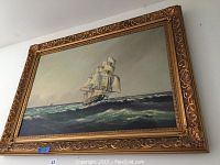 Full view of the framed ship sailing painting showing entire piece, frame and artwork.