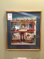 Front view of the watercolor art print framed in a gold frame and blue matte.