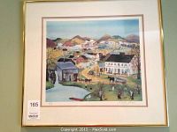 Framed art print of a rural village scene with buildings, hills, water wheel, people and horses. Print is signed and numbered 253/500 by Will Moses in pencil in lower margin. Framed in gold-colored metal frame with double matting.