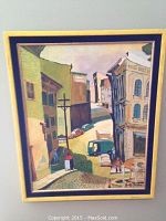 Full front view of the framed acrylic painting showing street scene with buildings, cars, and pedestrians. Signed Al Tudor at bottom right.