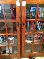 Close-up of both wood-framed glass doors filled with books