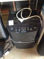 Front view of LG Energy Star dehumidifier with power cord on top and control panel visible.