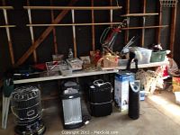 Two plastic folding tables, covered with miscellaneous items, spaced side by side with the smaller table at left and larger table at right.