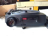 Front view of Kodak Carousel 750 slide projector showing lens and labelling plate.