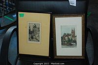 Both framed sketches displayed on a black chair. Left is the black and white Stanley Harrod engraving, right is the colored Basel sketch.