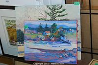 Two unframed paintings leaning against a display grid, front views of both canvases visible