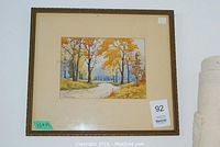 Full front view of the framed watercolor painting depicting an autumn landscape