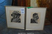 Two framed sketches side by side on floor