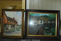 Two framed paintings of English cottages side by side: one brown cottage with stone fence, one white thatched roof cottage by bridge