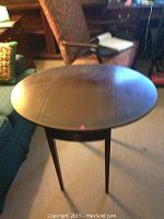 Photo of the oval drop leaf end table showing the extended top surface and spindle legs
