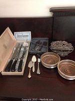 Full view of all items including carving knife set, cheese knives, coasters, trivet, and servers on table