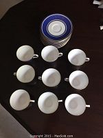 Top view of Royal Doulton Windsor and New Chelsea Staffs cups and saucers arranged on table.