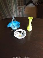 Blue and white footed art glass basket with rope work handle, showing seashell-shaped feet and basket shape