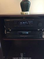 Sherwood DRS receiver and Sony 5 CD changer stacked in audio cabinet.