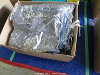 Assorted men's swim trunks in plastic packaging inside a box