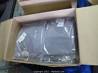 Two packaged light grey sweaters in cardboard box