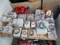 Overview photo showing many decorative frames arranged on table, some wrapped and boxed