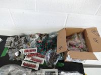 Boxes and bags filled with assorted costume jewelry, bracelets and necklaces