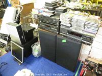 Overall view of stacked audio components, speakers, monitor and media collections