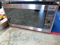 Front view of Panasonic Inverter microwave NNSD691S showing stainless steel exterior and digital control panel.