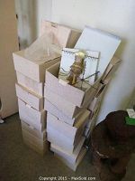 Stacked cream-colored boxes containing jewelry holders, some partially open revealing the holders inside.