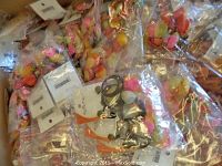 Box filled with individually packaged colorful bead earrings and necklaces.