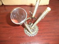 Ornate butterfly filigree stand with three vertical holders, magnifier and letter openers in front