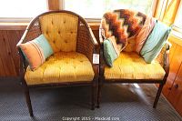 Overview of both chairs side by side in front of window with pillows and afghan