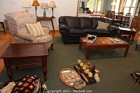 Pair of wood end tables in a living room setting, showing their dark wood finish and design details.