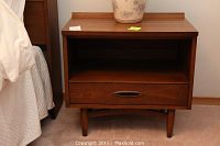 Pair of wooden night stands, each with single drawer and open shelf, showing overall condition and finish.