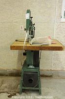 Front view of Canwood bandsaw showing wooden table and base