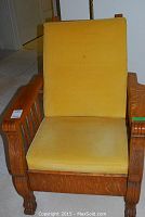 Front view of oak Morris chair showing mustard-yellow corduroy cushions