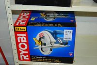 Photo of the boxed Ryobi circular saw showing branding, 12 Amp motor and blade size.