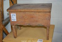 Front and side view of wooden shoe shine box with hinged lid, showing natural wood finish and structural details.