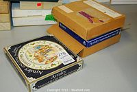 Four boxes containing Aynsley collector plates with Christmas themes.