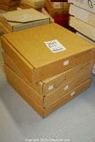 Stack of four cardboard boxes labeled with plate series names for the Hamilton collector plates lot.
