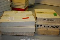 Photo of six box containers for the collector plates for storage and protection.