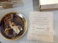 Collector plate titled 'Dreaming in the Attic' with certificate of authenticity alongside it.
