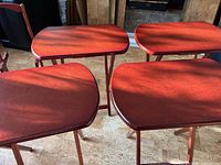 four mahogany-finish folding tables set up