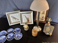 Full lot showing candle lamp, Delft plates, framed prints, Hummel items, owl holder, photo frame, candle
