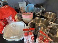 Group shot showing saucepans, casserole, BBQ pan, blender jar, cups, wire rack, pouch