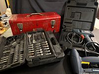 Overall view of drill, toolbox, bit kit and cases
