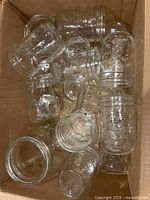 Top view of box showing assorted clear canning jars